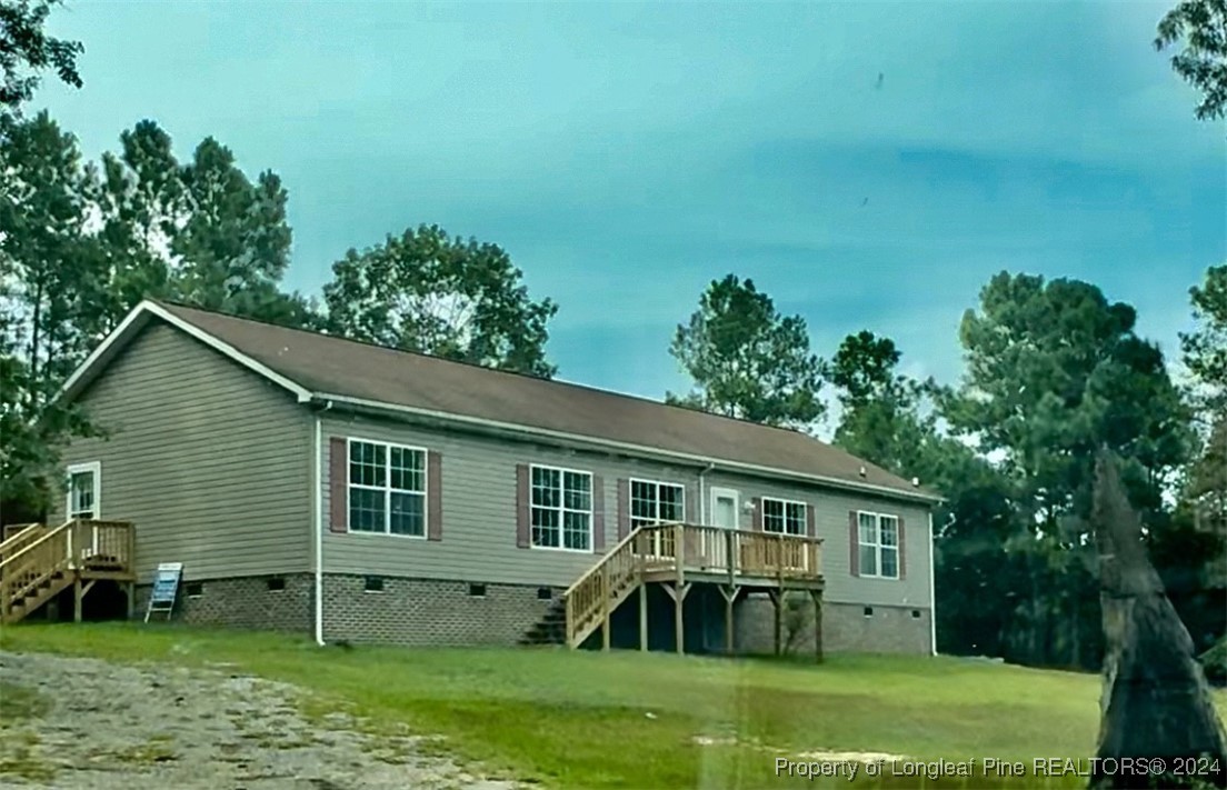 a view of a house with a yard porch and sitting area