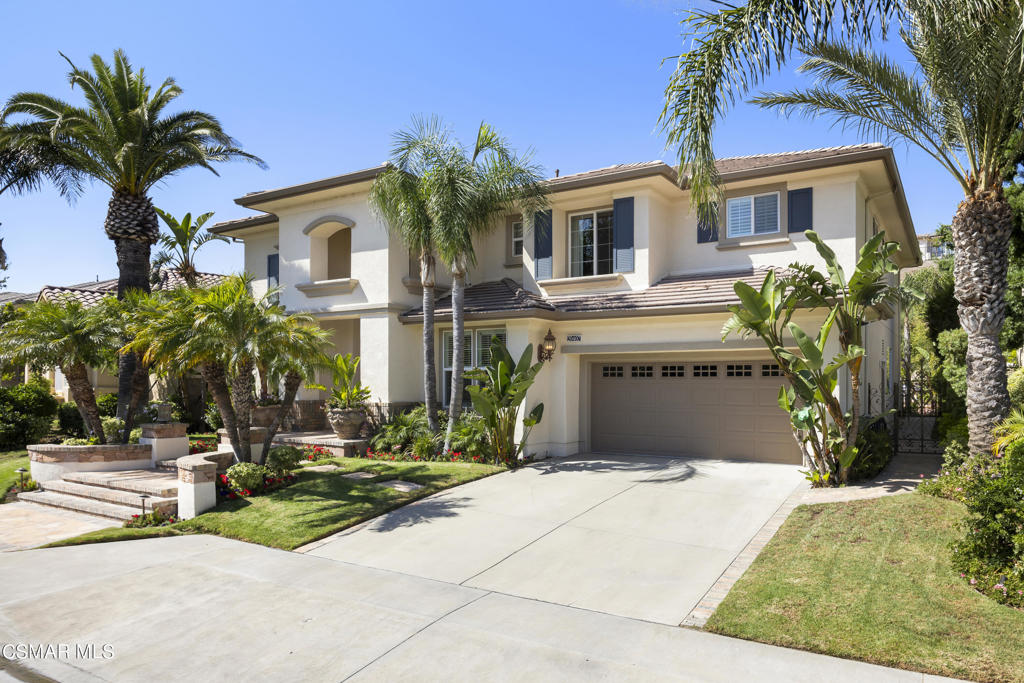 a front view of house with yard and trees around