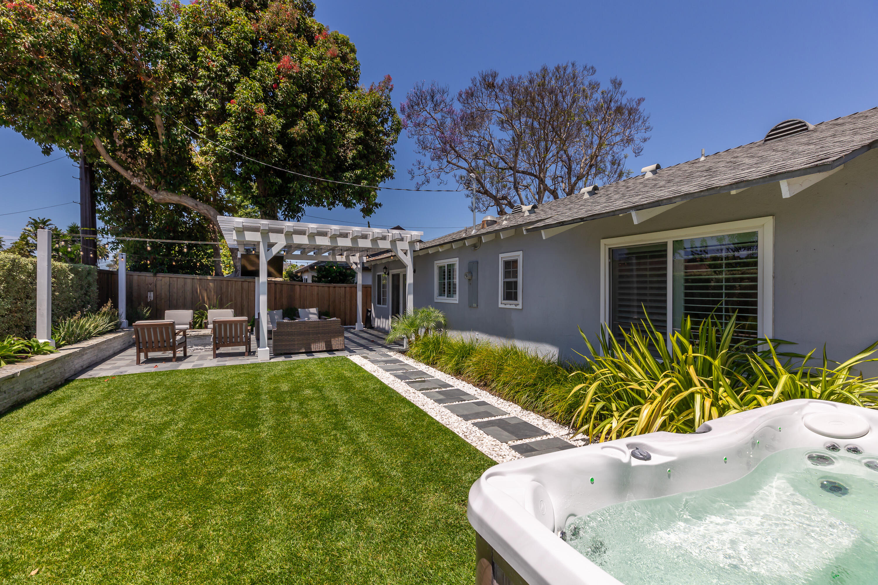 a view of a house with a yard patio and swimming pool