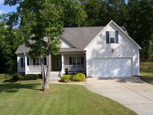 a front view of a house with a garden and porch