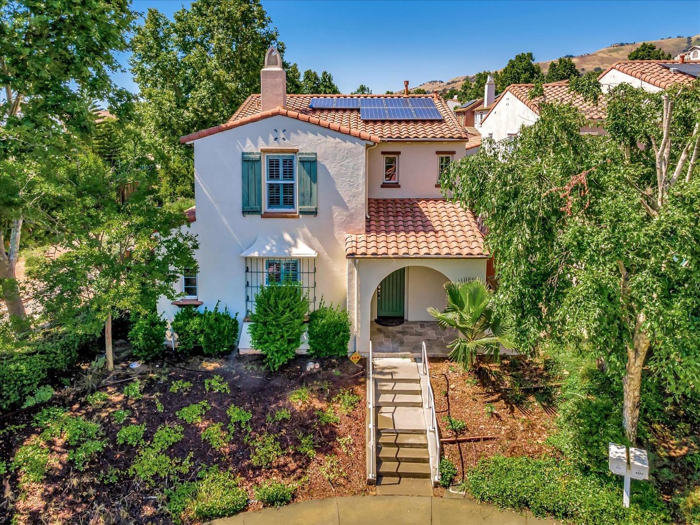 a front view of a house with plants