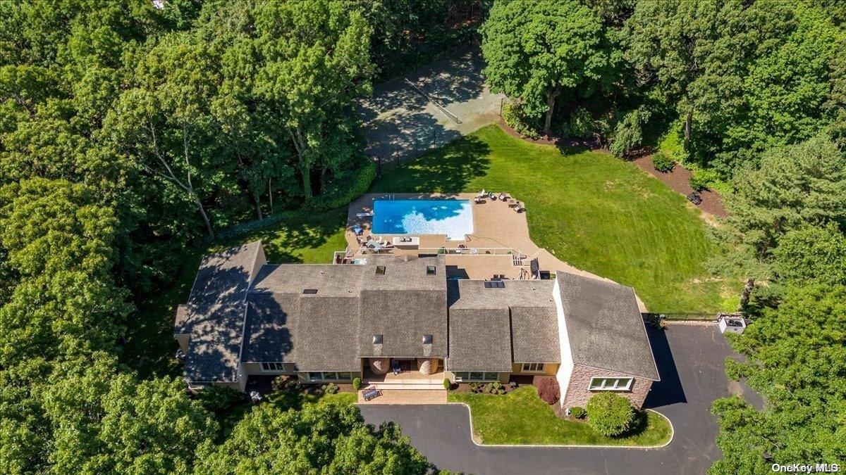 an aerial view of a house with a garden and trees