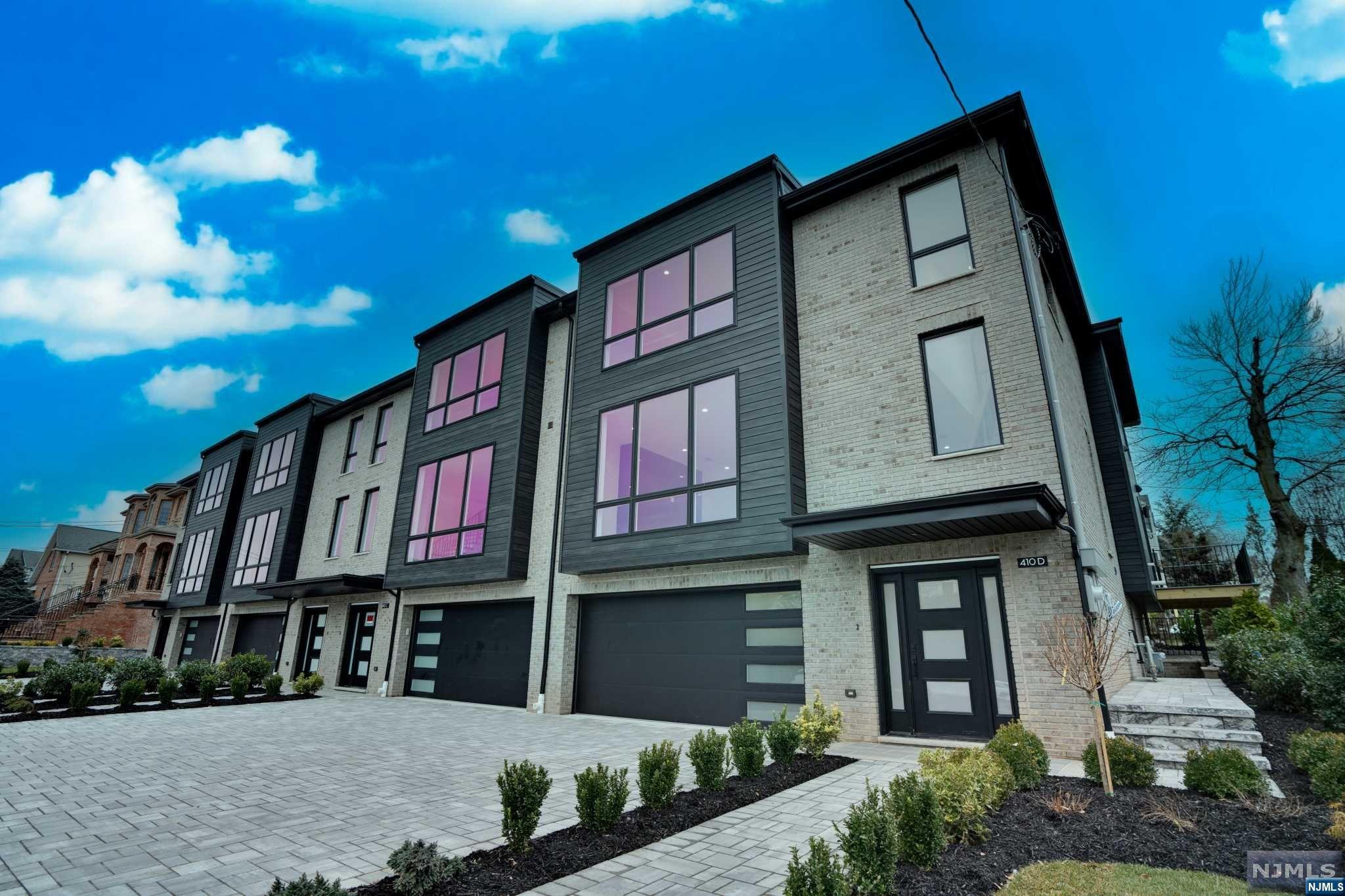 a front view of a residential apartment building with a yard