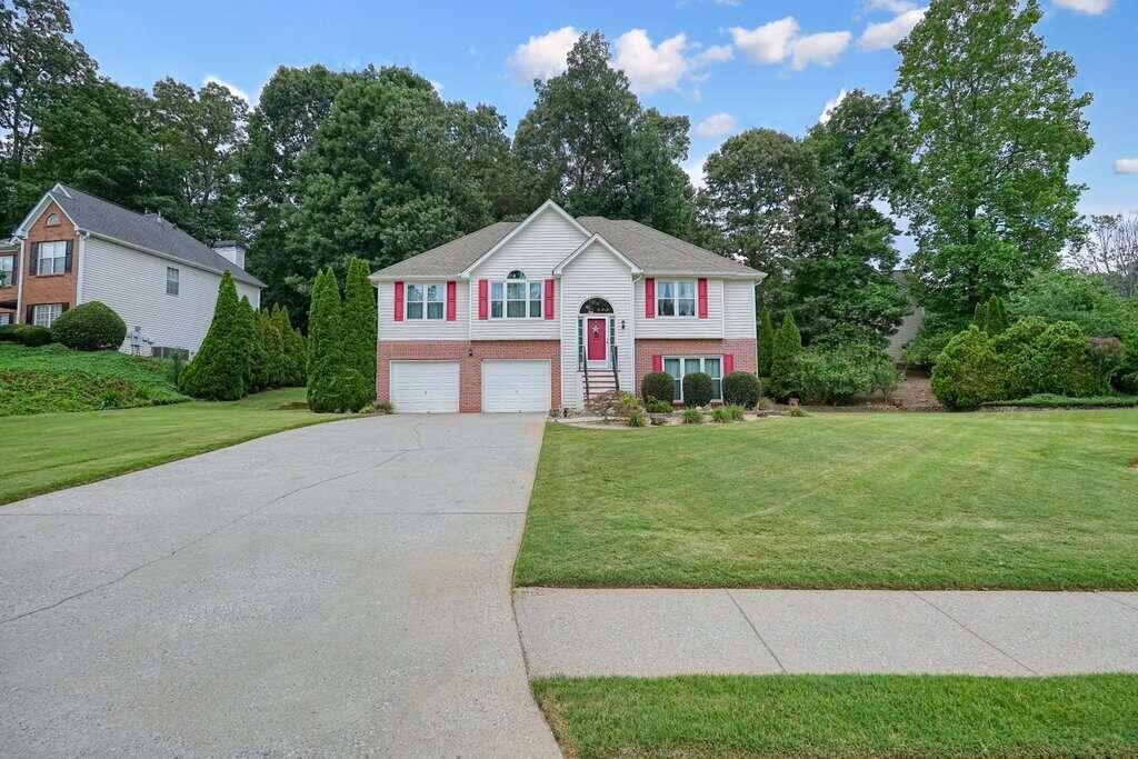 a front view of a house with a yard and garage