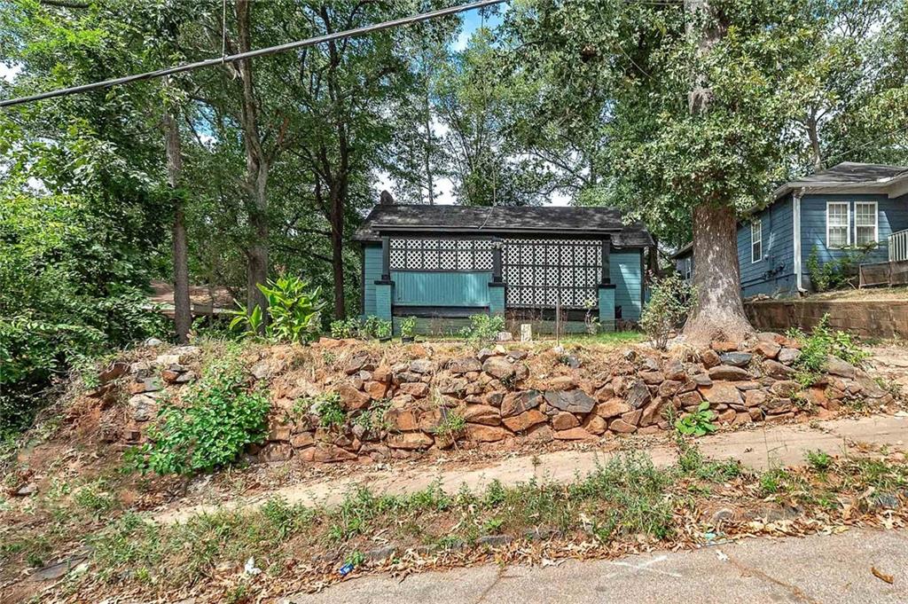 a view of a house with a tree and yard