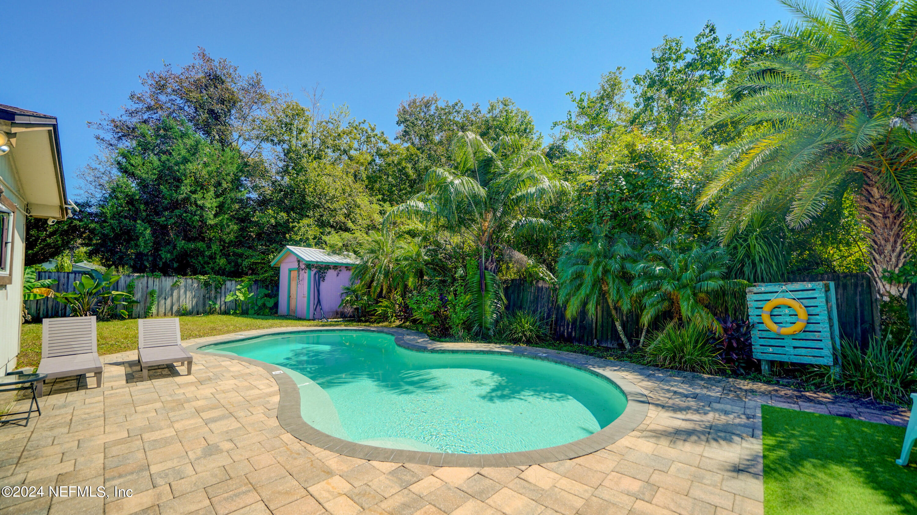 a view of a backyard with swimming pool