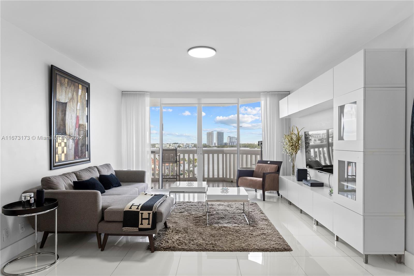 a living room with furniture rug and a table