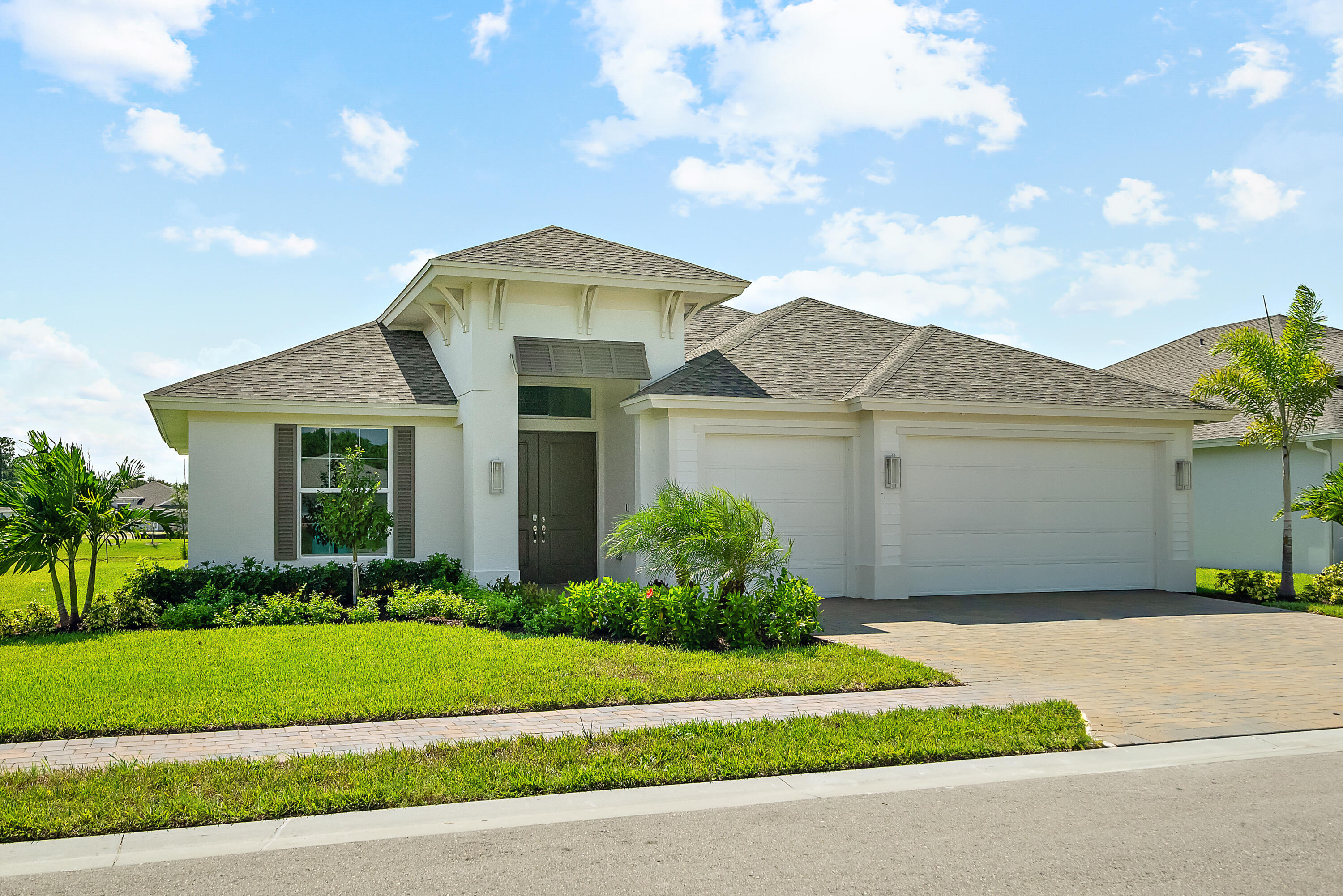 a front view of a house with a garden