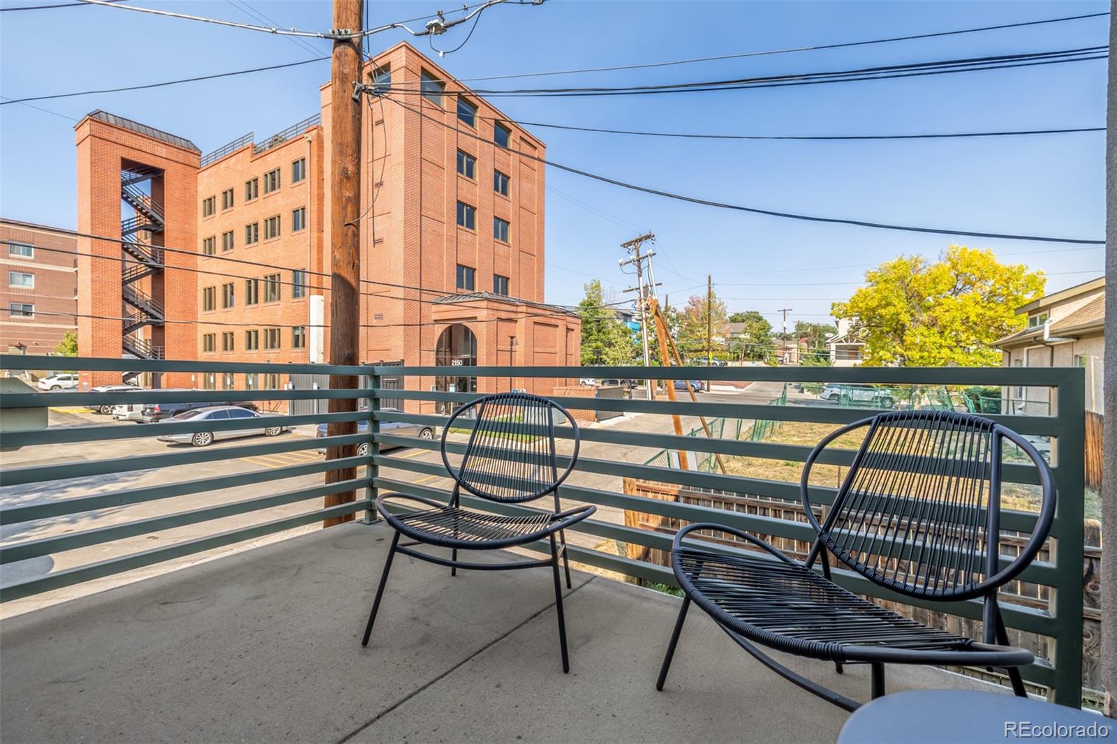 a view of a chairs and table in the balcony