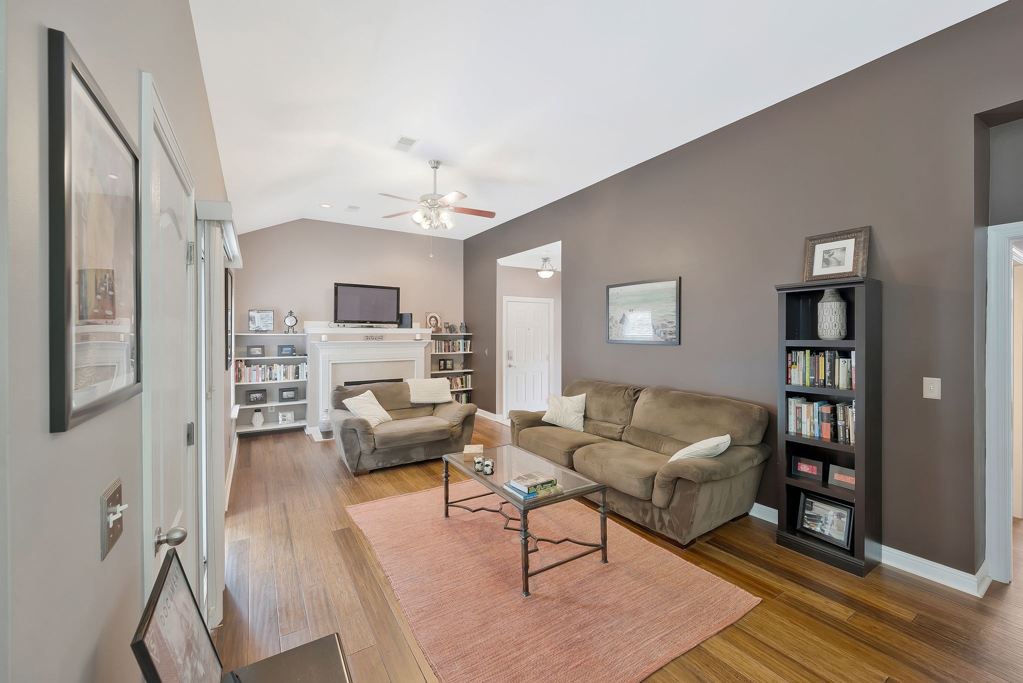 a living room with furniture and a wooden floor