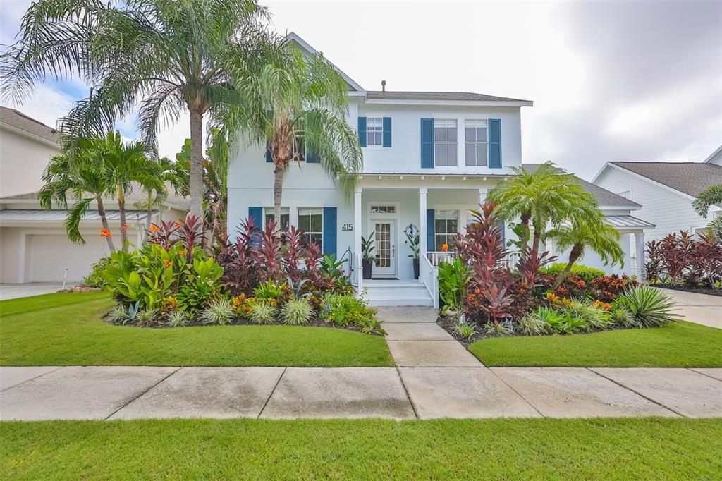 a front view of a house with a garden