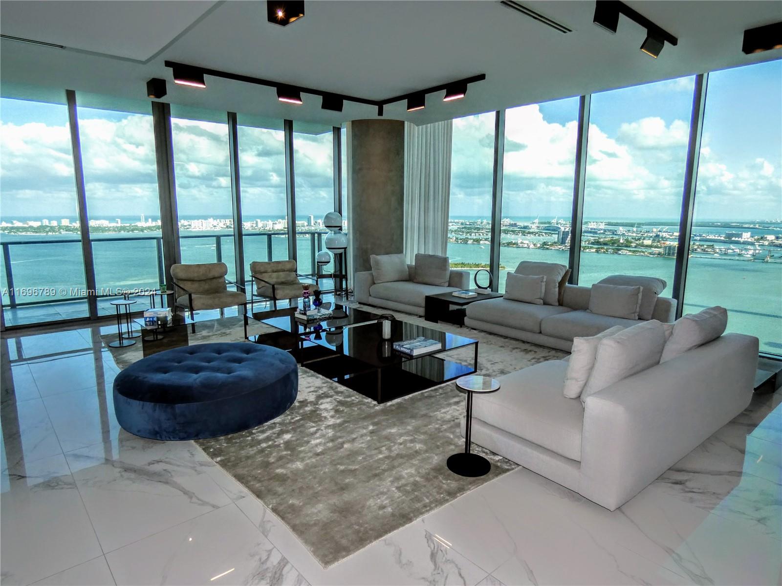 a living room with furniture and a floor to ceiling window