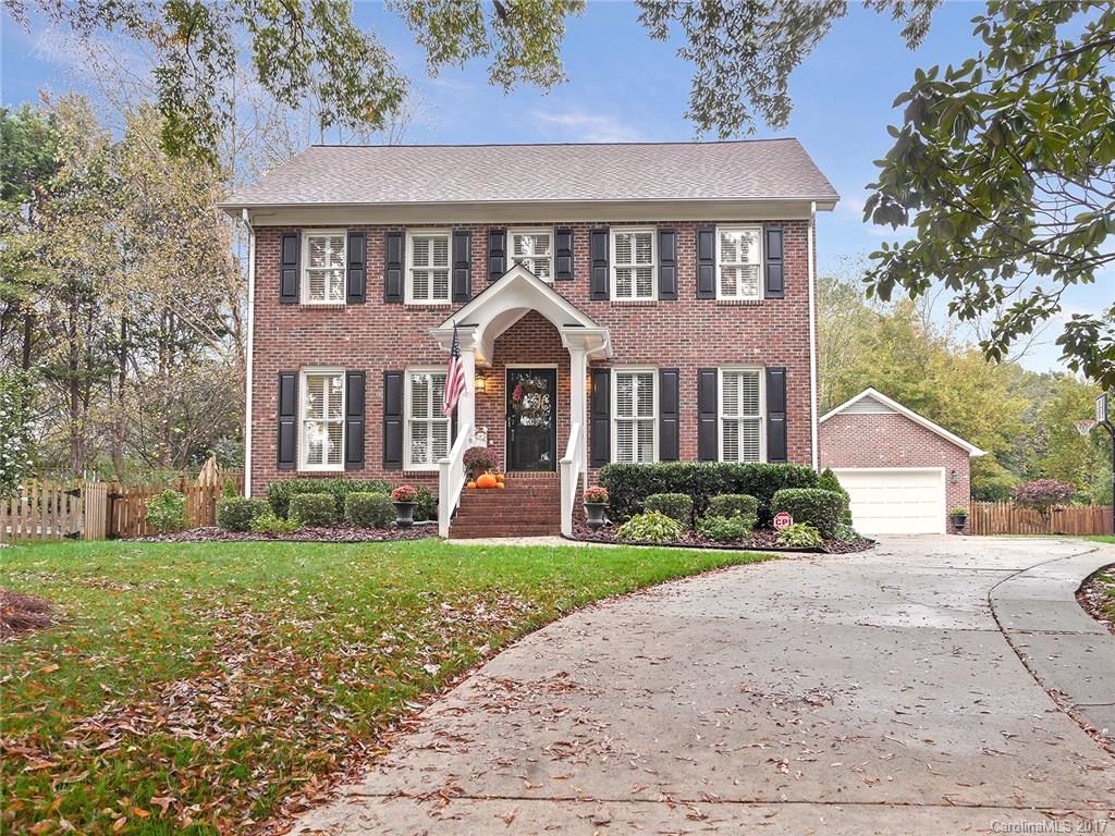 front view of a brick house with a yard