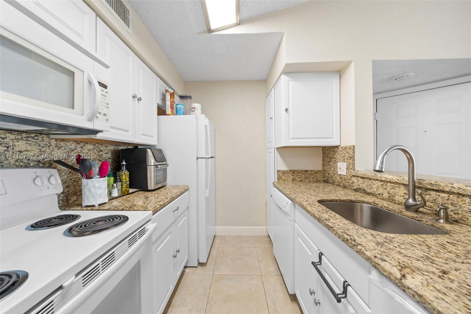 a kitchen with kitchen island a sink stove and refrigerator