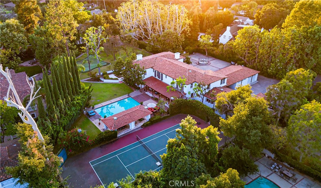 an aerial view of a tennis ground and large trees