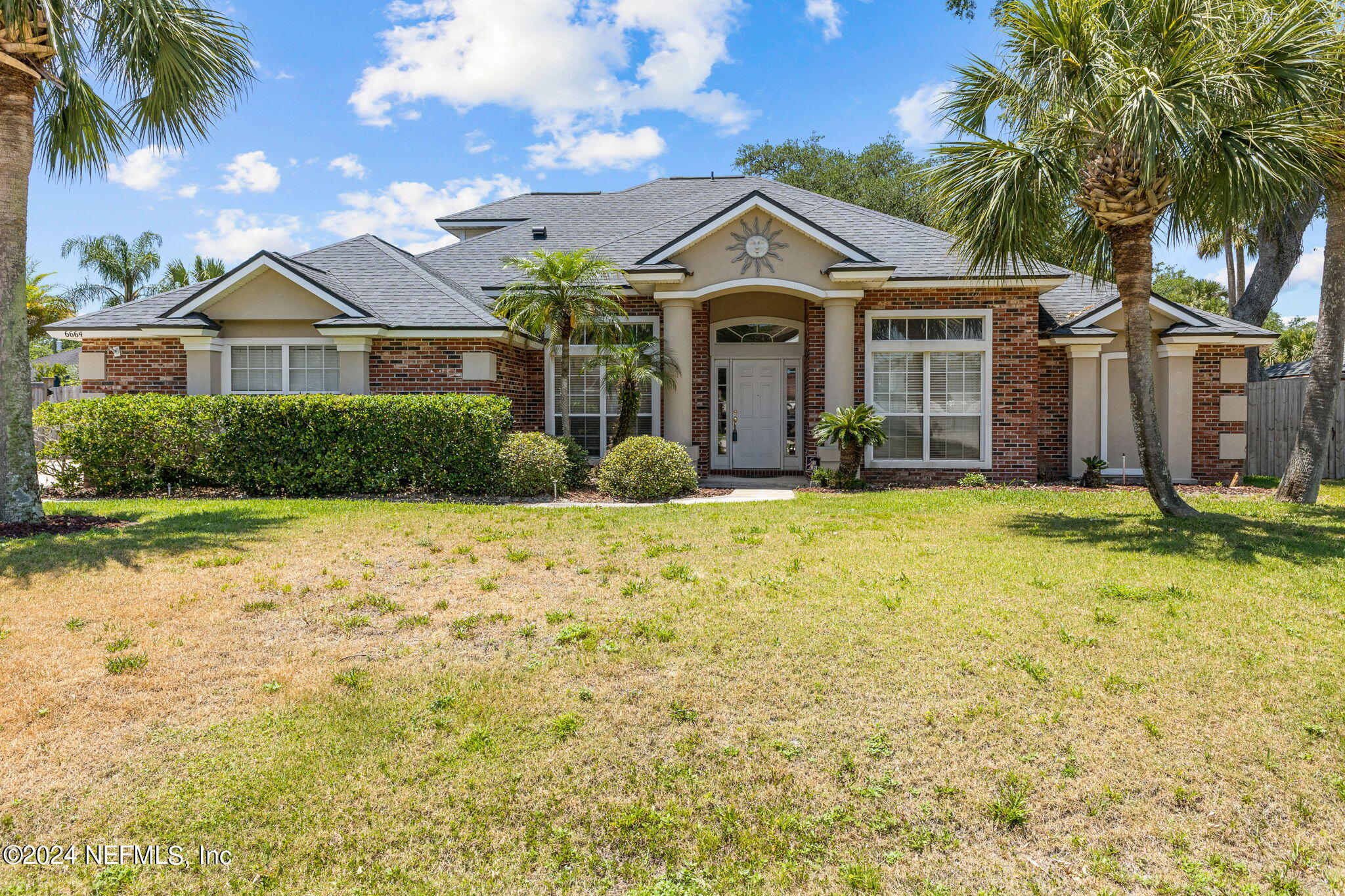 a front view of a house with a yard