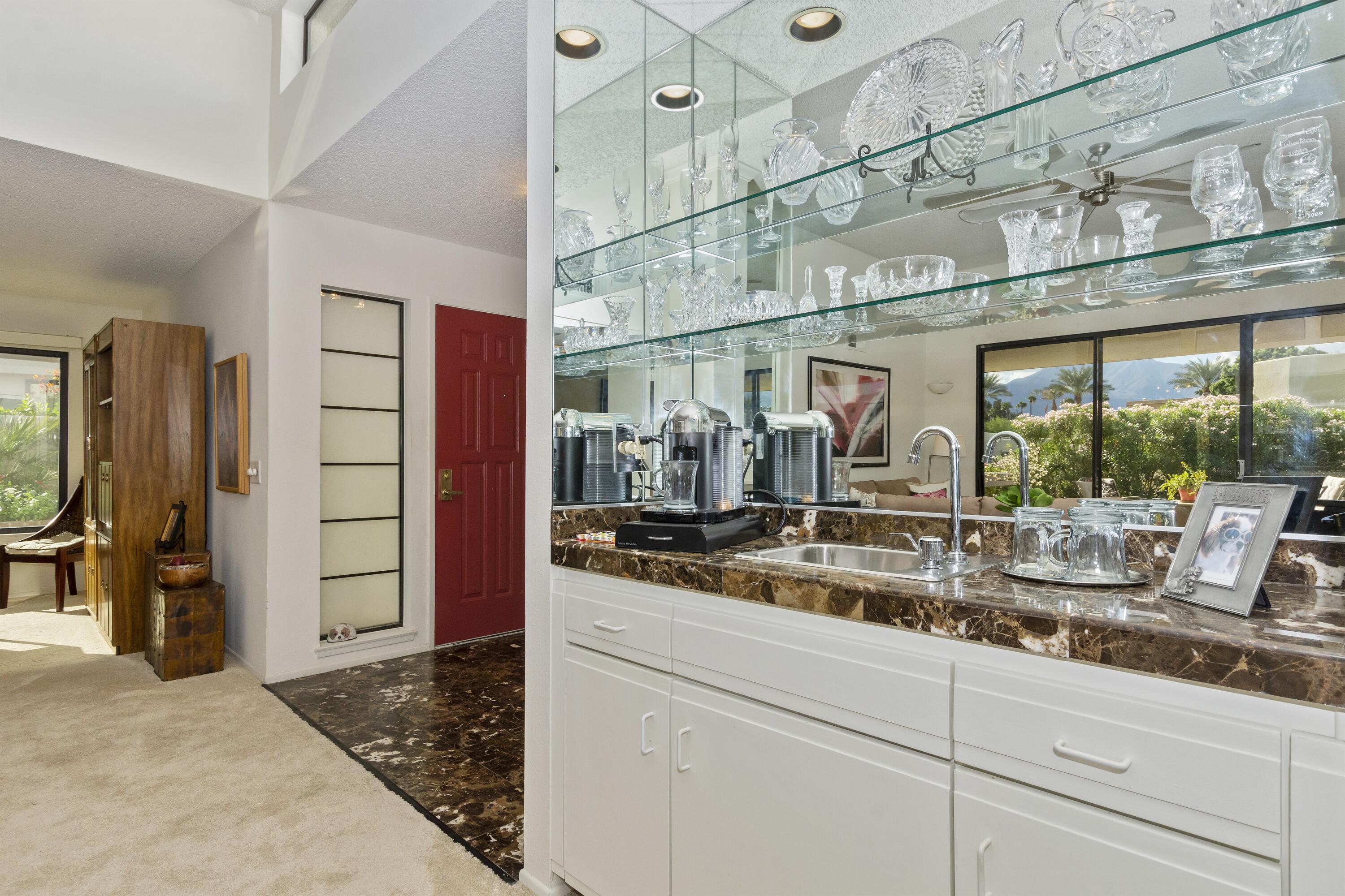 a kitchen with stainless steel appliances granite countertop a sink and cabinets