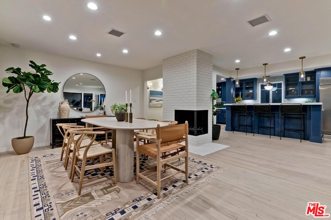 a large kitchen with a table and chairs in it