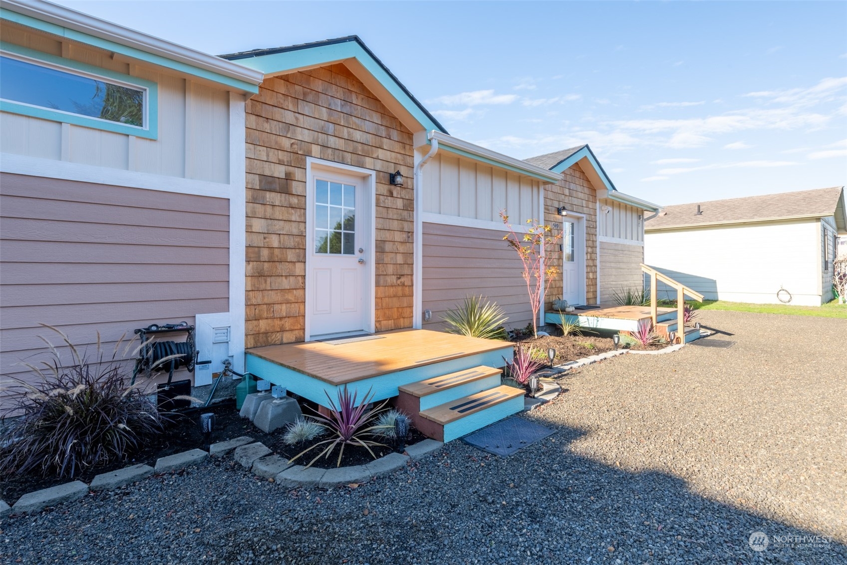 a view of a house with backyard and sitting area