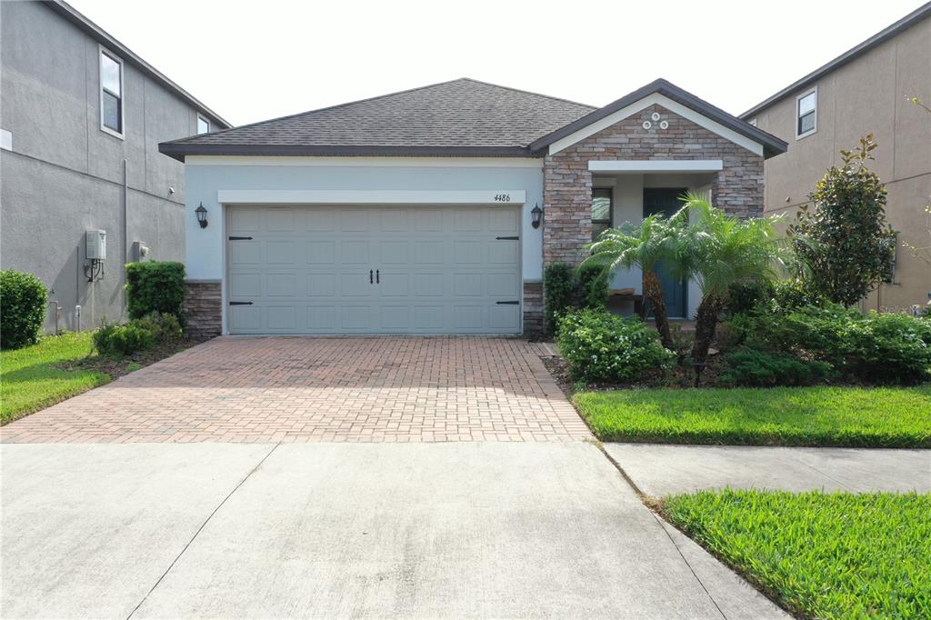 a front view of a house with a yard and garage