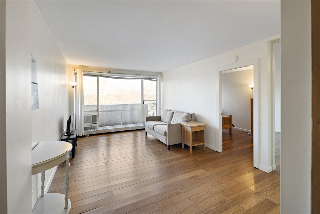 a bedroom with furniture and a large window