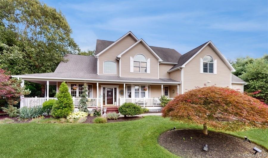 a front view of a house with a yard and green space