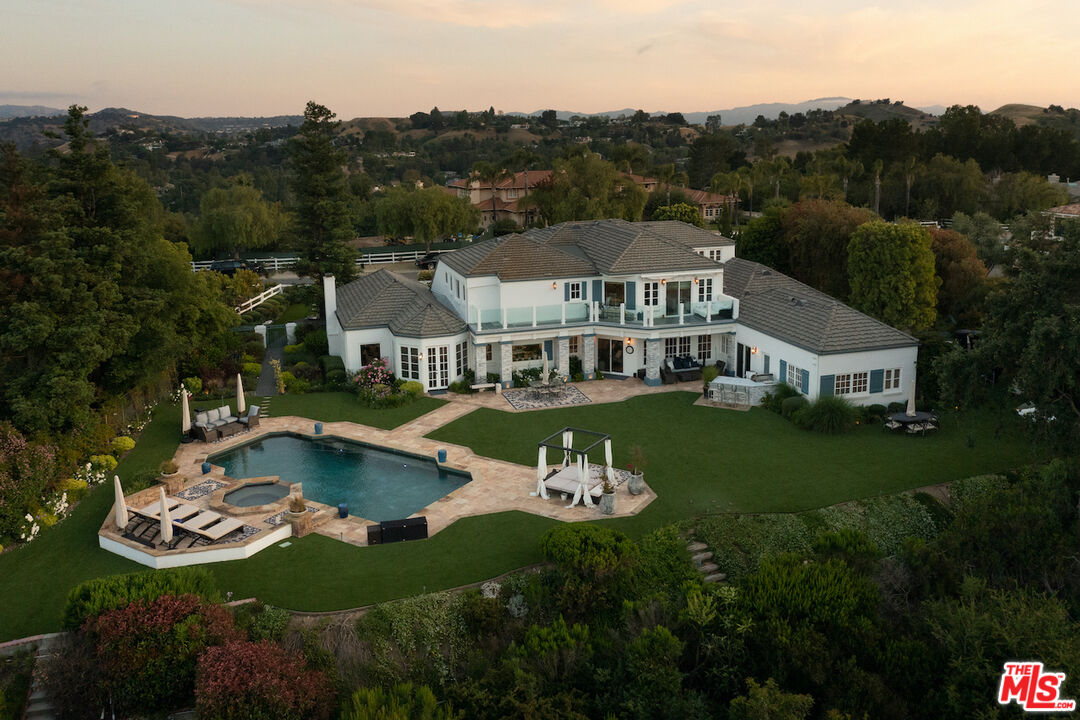 a view of a house with swimming pool and a yard