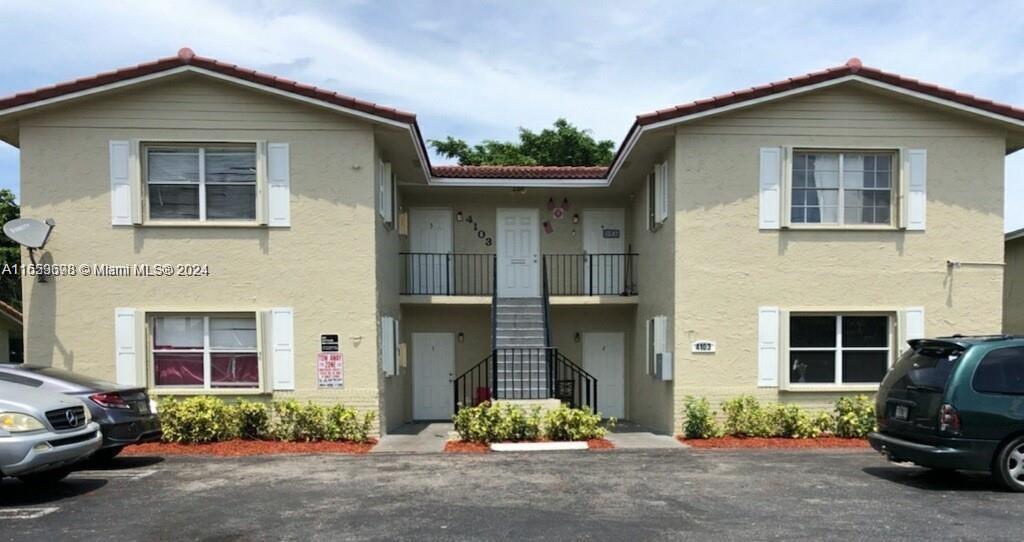 a view of a car park front front of a house