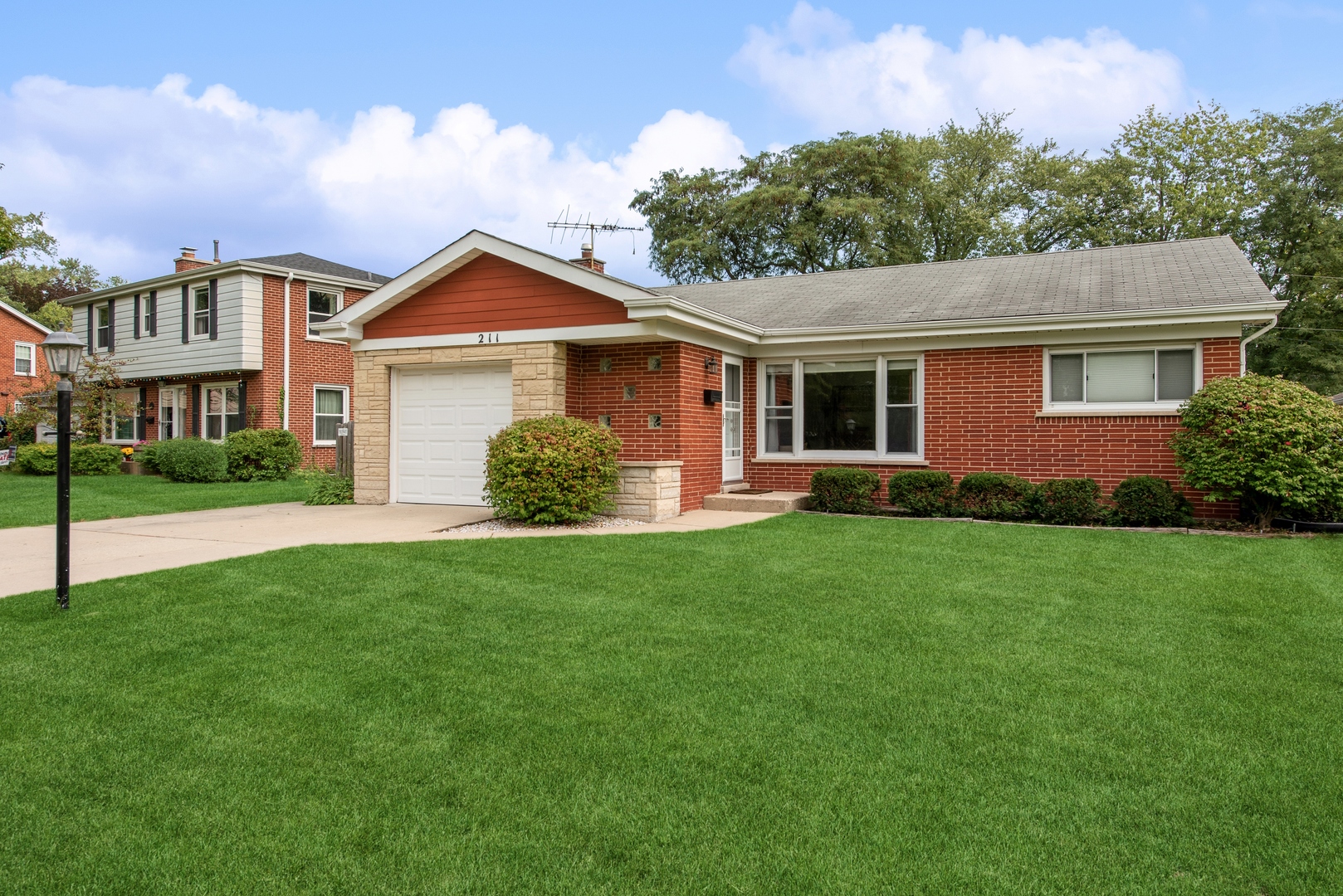 a front view of house with yard and green space