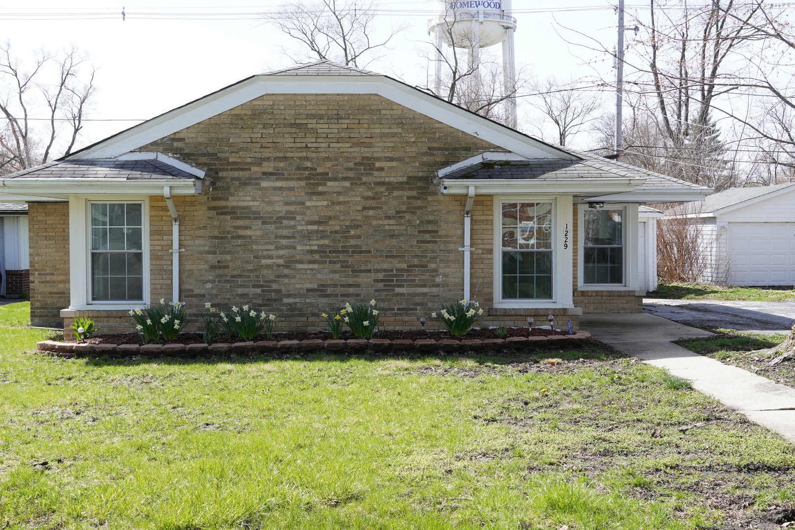 a front view of a house with a garden