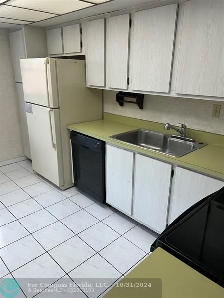 a kitchen with a refrigerator and cabinets