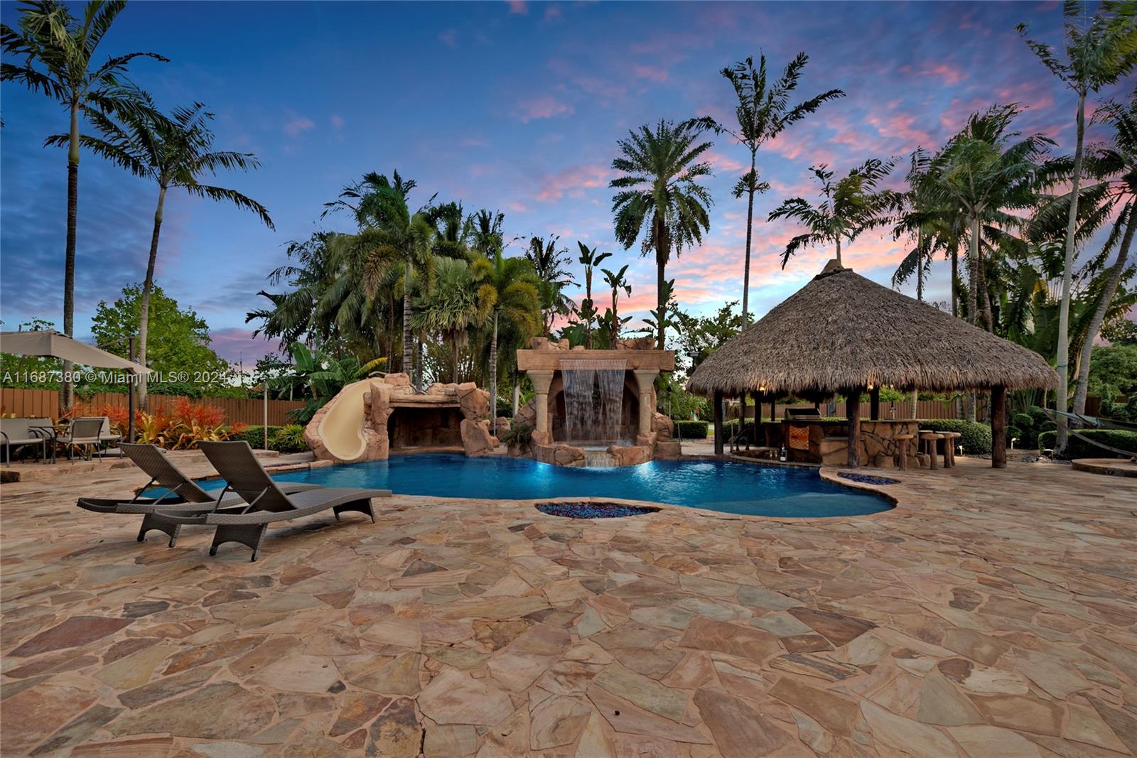 a view of a house with swimming pool and sitting area