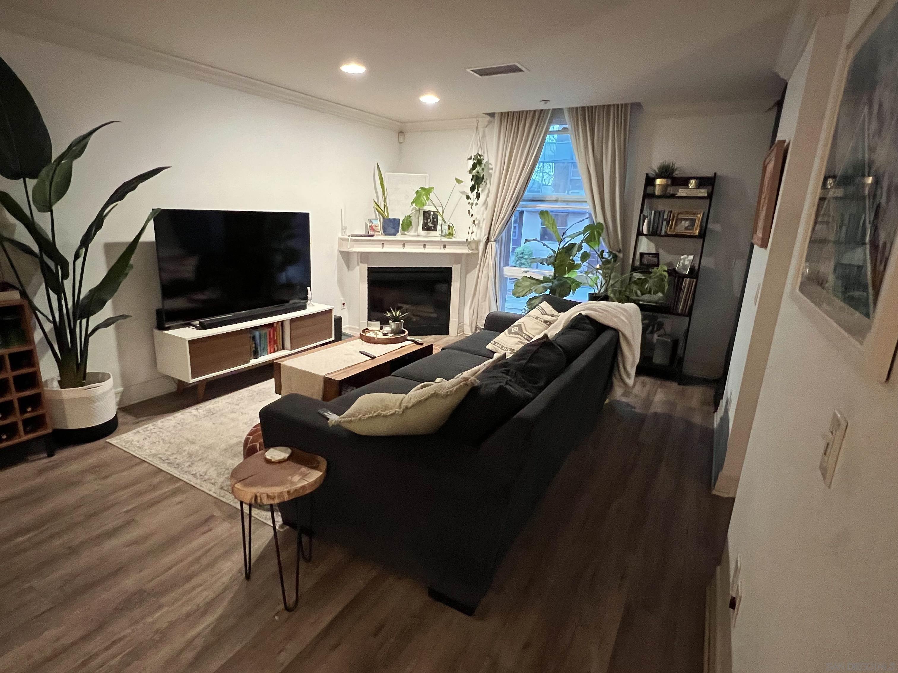 a living room with furniture fireplace and a flat screen tv