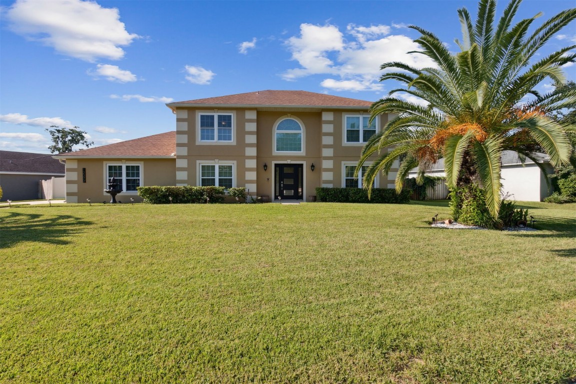 a front view of house with yard and green space