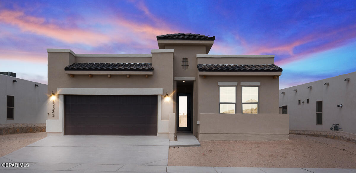 a front view of a house with a garage