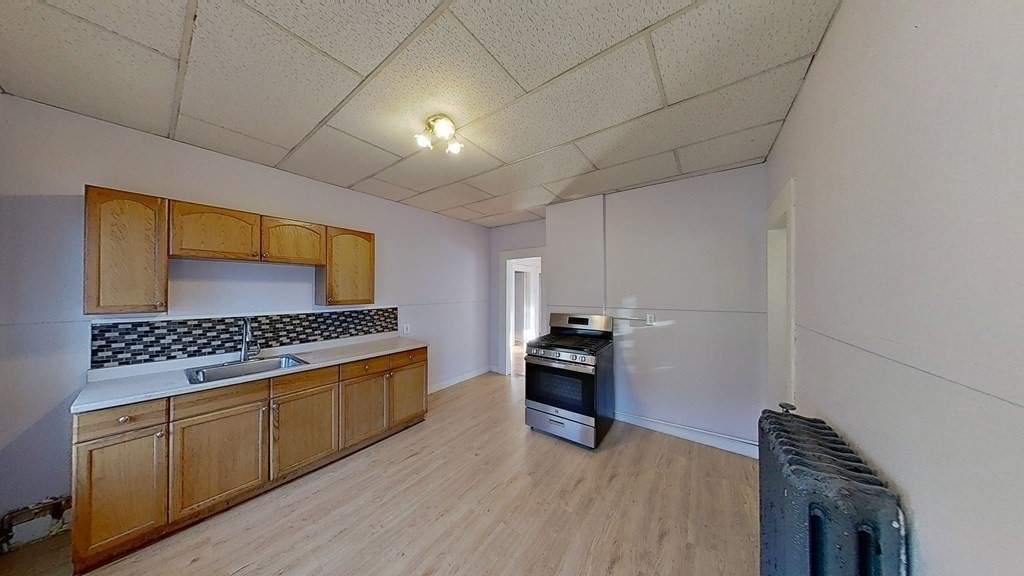 a kitchen with stainless steel appliances granite countertop a stove a sink and a refrigerator