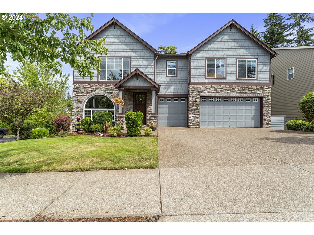 a front view of a house with a yard and garage