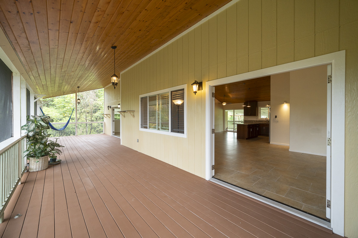 a view of outdoor space with wooden floor and windows