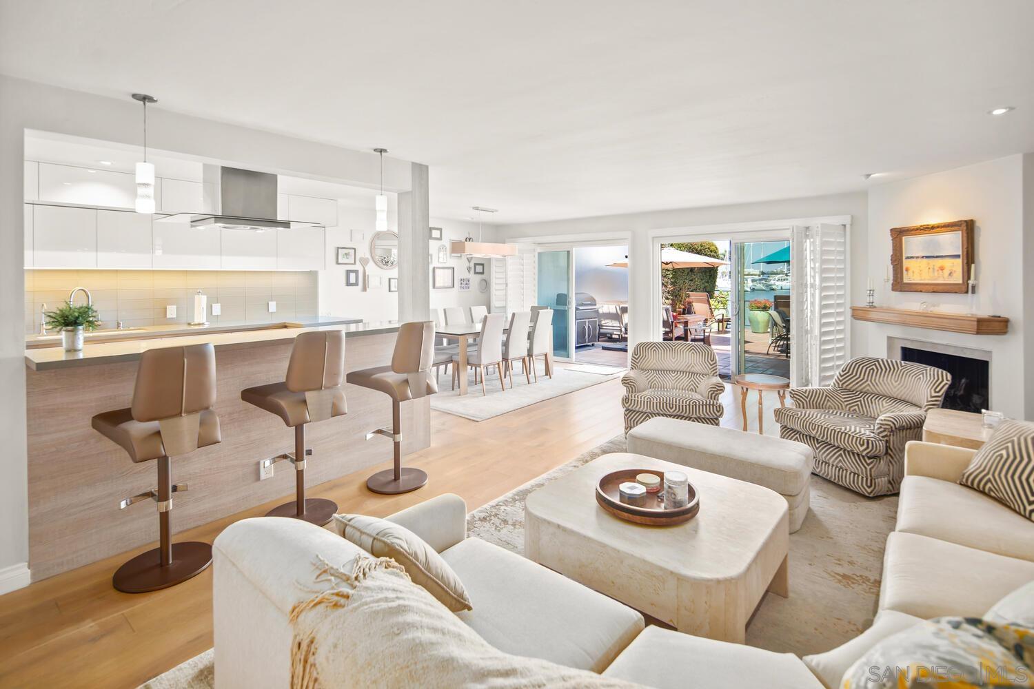 a living room with furniture and a kitchen view