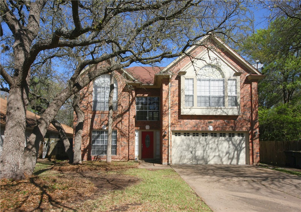 a view of a house with a windows and tree