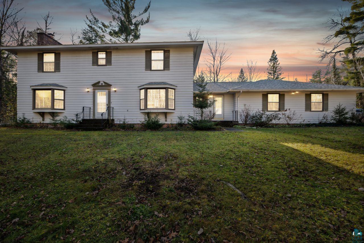 View of front of property with a lawn