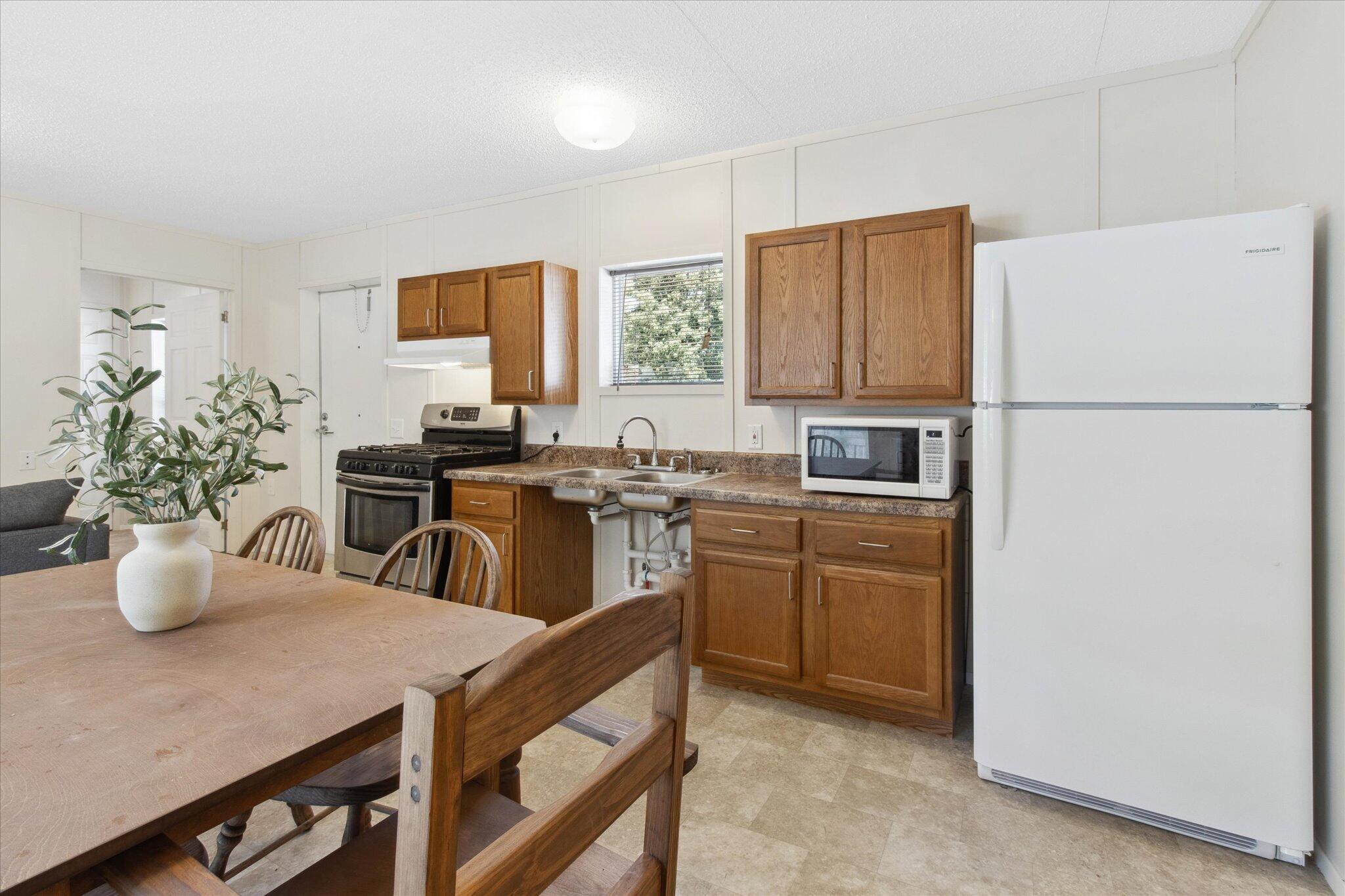 a kitchen with a refrigerator and a sink