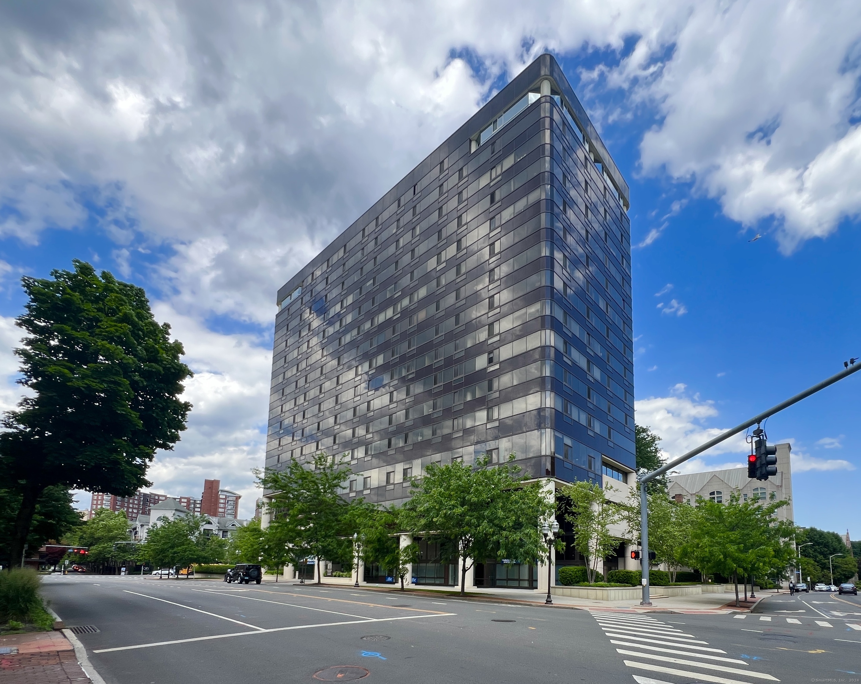 a view of a tall building next to a road