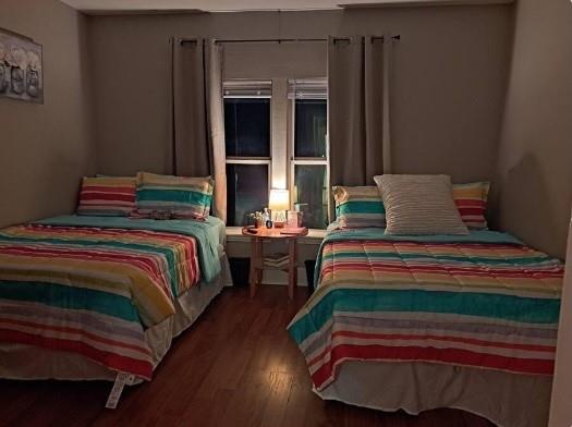 a bedroom with a bed and windows