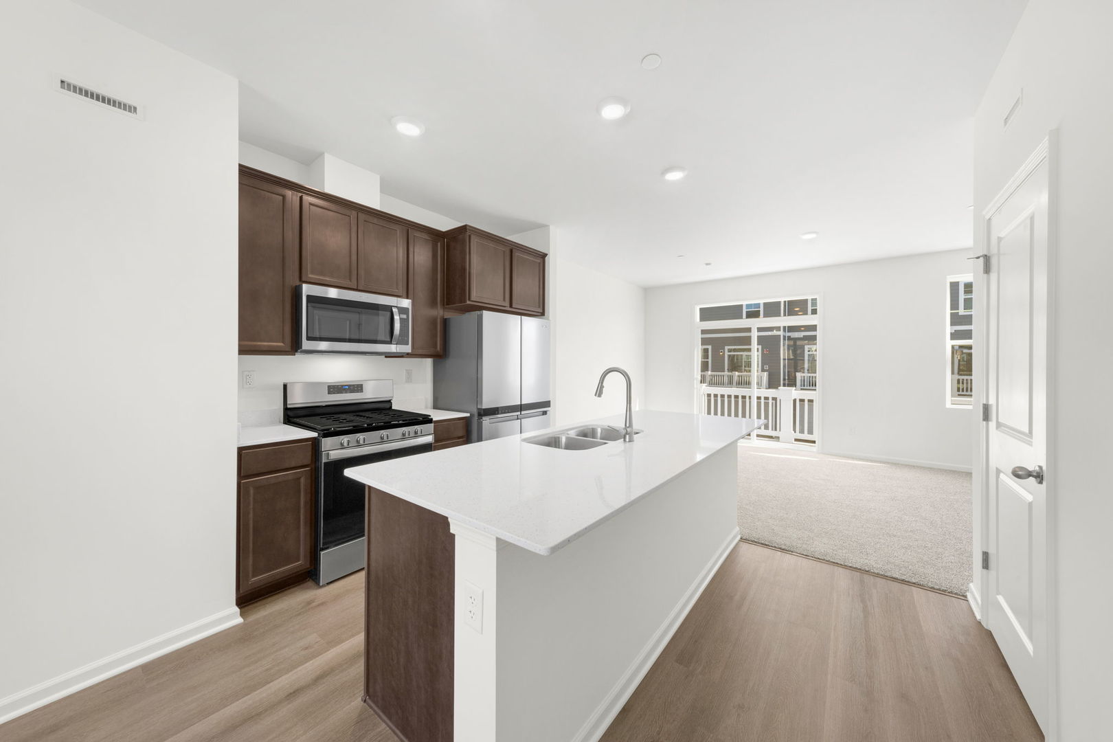 a kitchen with a stove a sink and a refrigerator