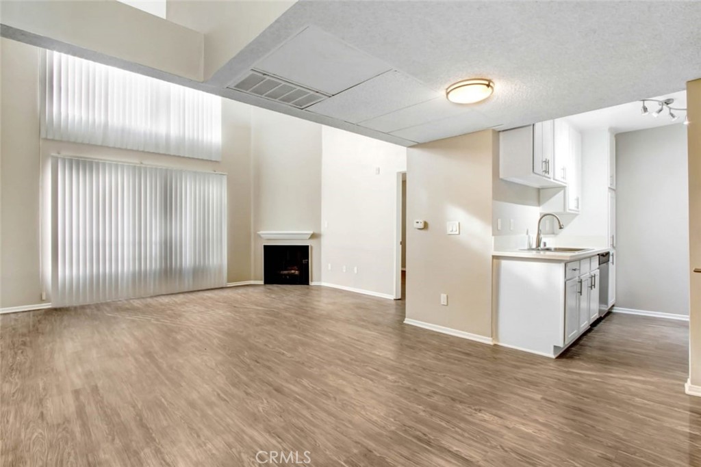 a view of a kitchen with wooden floor and a kitchen