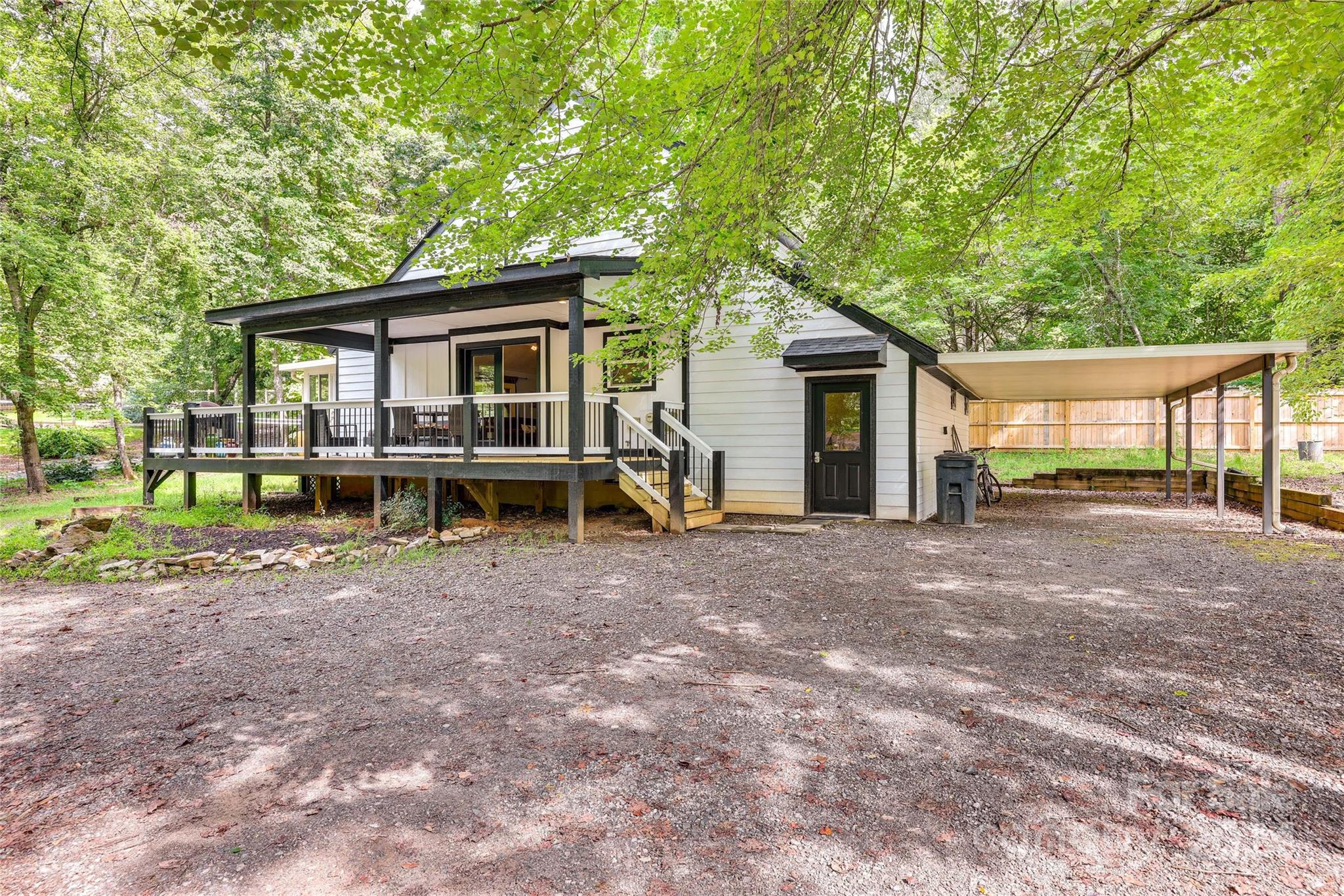 a view of a house with backyard and a tree