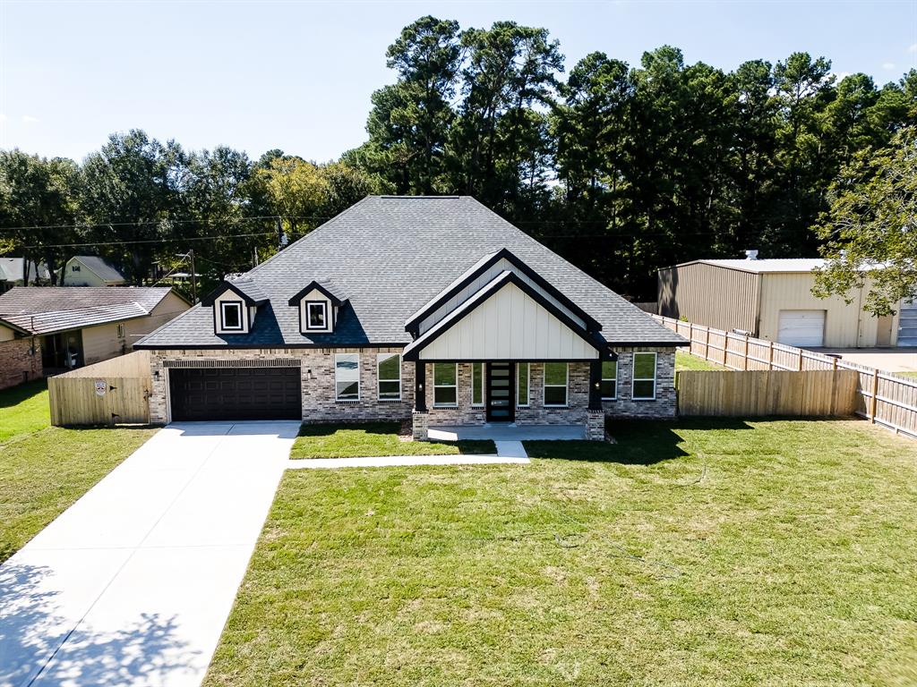 a house view with a seating space and garden