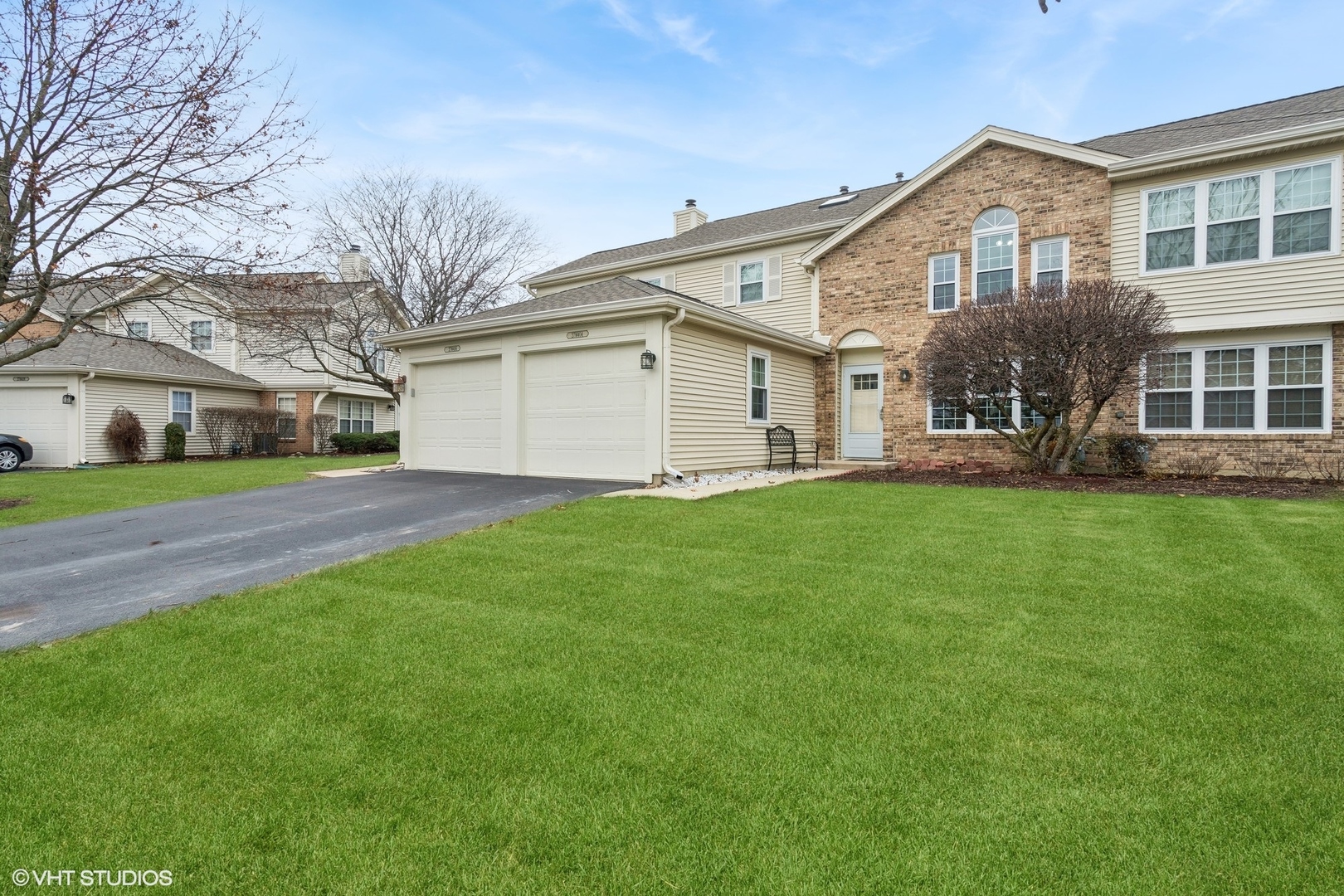 a front view of house with yard and green space