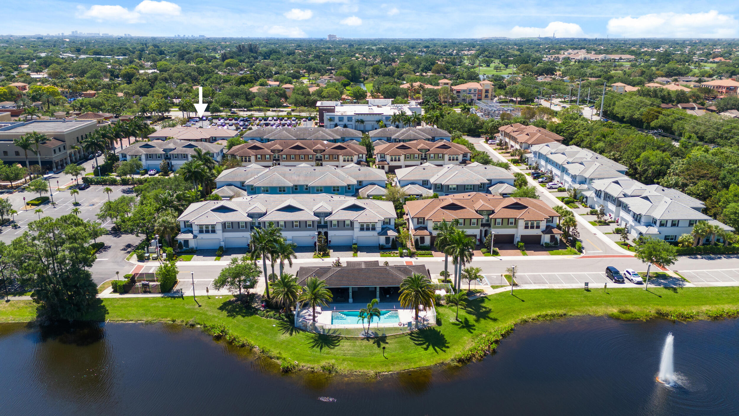 an aerial view of a house with a swimming pool yard and lake view